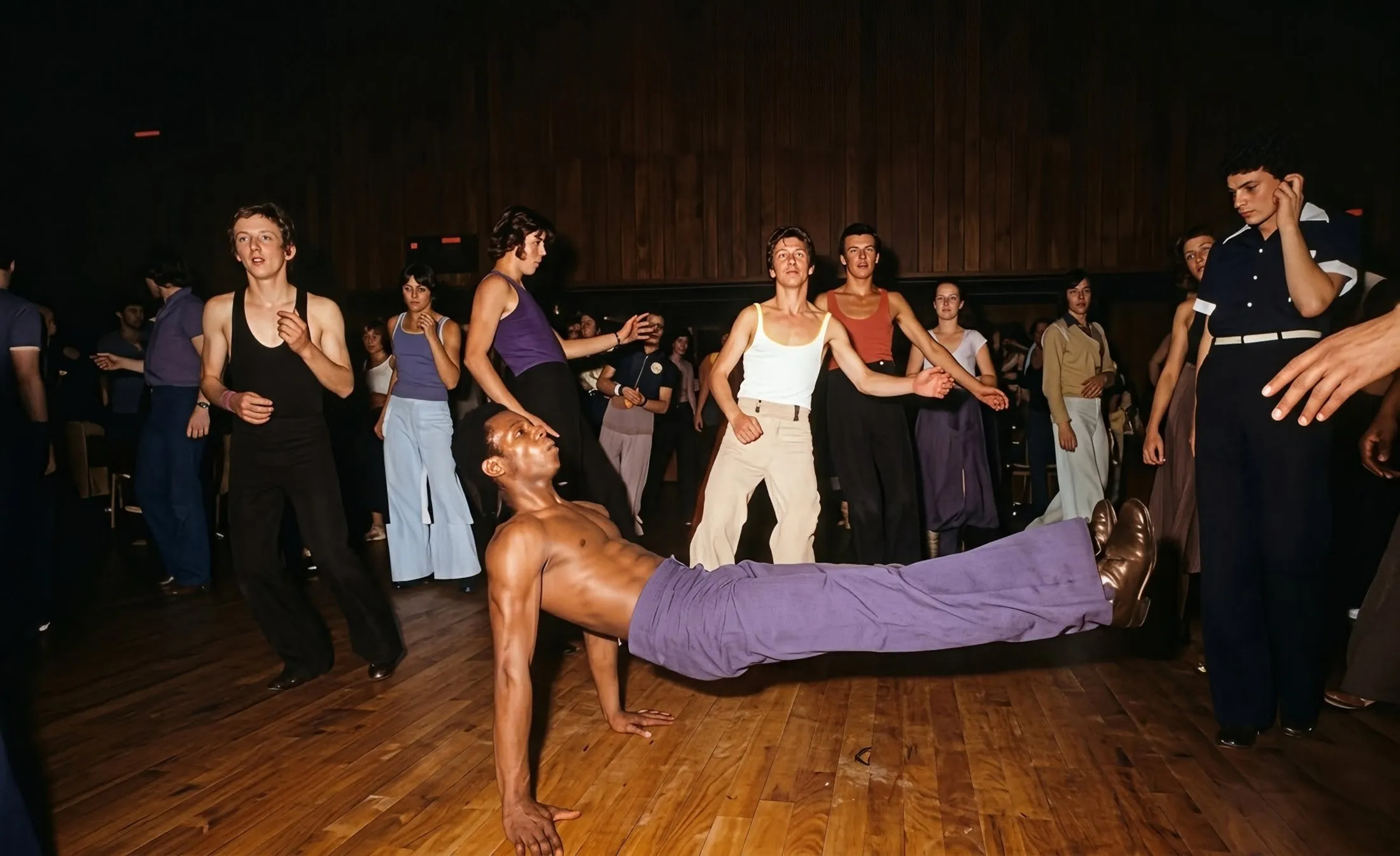 A dancer drops back to the floor on a crowded Northern Soul dance floor, a still from the film Northern Soul
